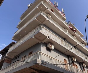 A multi-story building with balconies, air conditioning units, and a clear sky. - Ollection O Sector 95B Gurgaon (Gurugram)