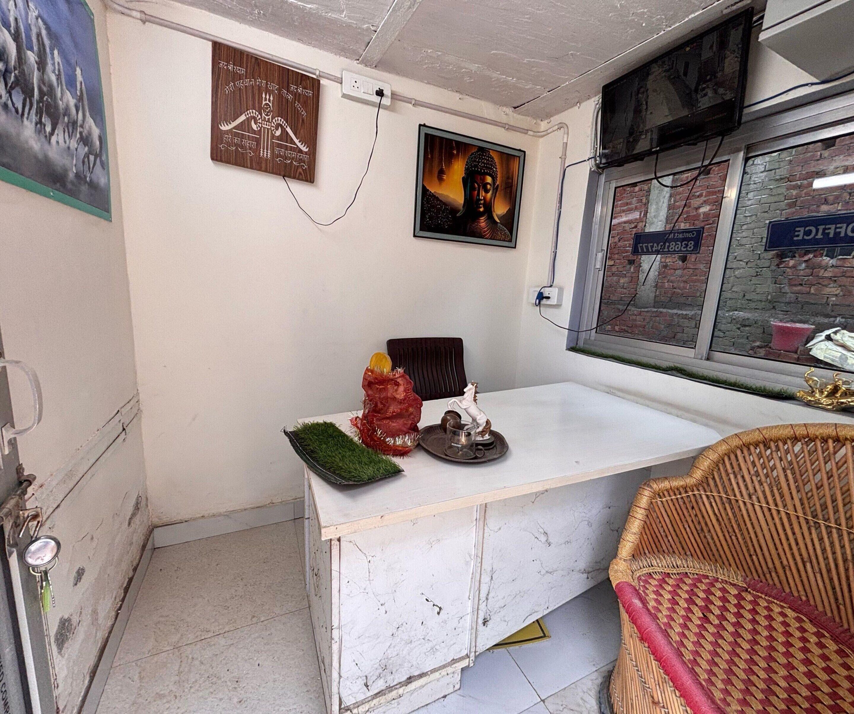 A room with a white marble counter, a wicker chair, and a window with a view of a brick building.