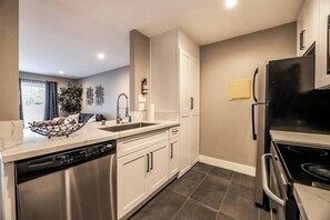 A modern kitchen with a dishwasher, stove, and refrigerator. - Glasgow Suite 1b/1b entire condo (Las Vegas)
