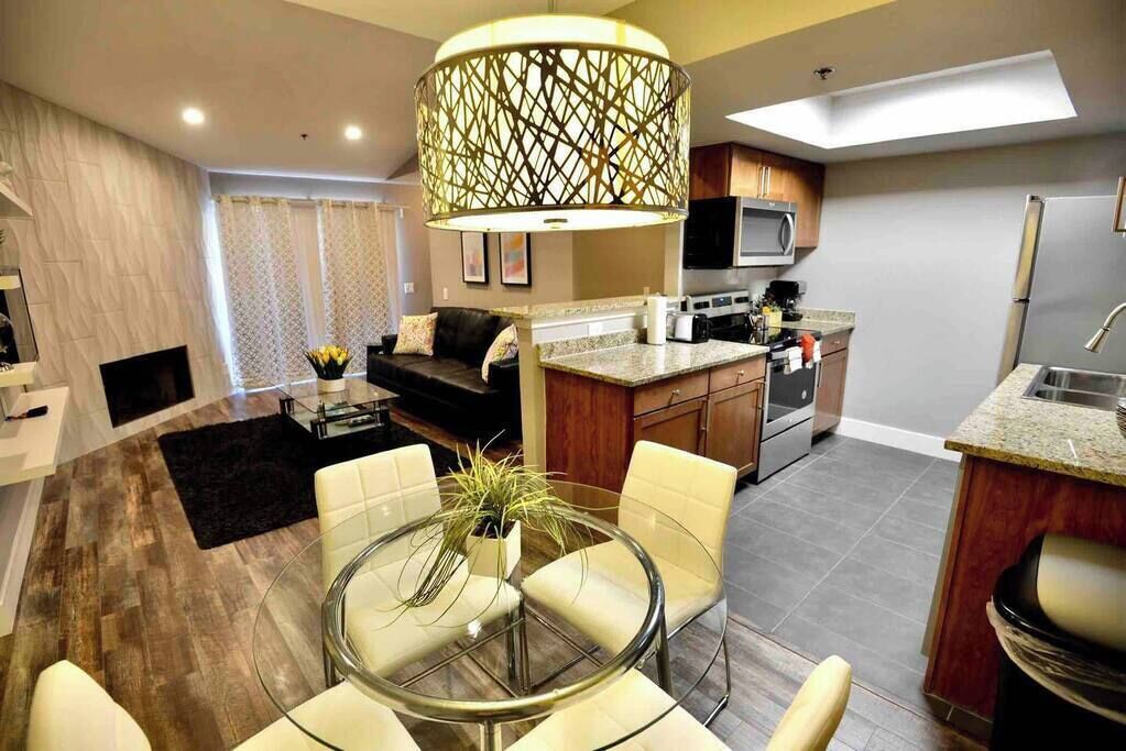 A modern kitchen with a microwave, stove, and refrigerator.