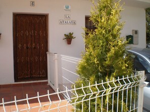 A building entrance with a metal gate, a wooden door, and a sign that reads 'LA ATLALAYA'. - La Atalaya de Los Romanes: Tourismus und Urlaub. by Interhome (Los Romanes)