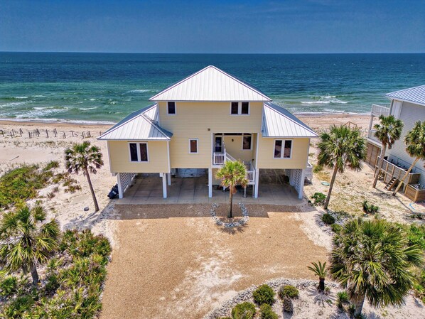 A two-story beach house with a covered patio and a view of the ocean. - Sea Glass, Beach Front, Renovated, Community Pools, Beach Gear Credit! (St. George Island)