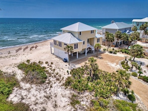 A beachfront property with multiple houses, a sandy beach, and the ocean in the background. - Sea Glass, Beach Front, Renovated, Community Pools, Beach Gear Credit! (St. George Island)