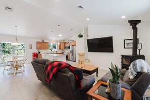 A modern living room with a sofa, a coffee table, and a fireplace.