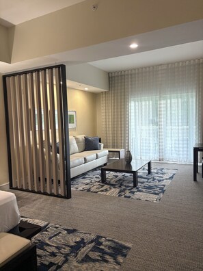 A modern living room with a sofa, coffee table, and a patterned rug. - Modern Luxury one bedroom apartment in Doral Florida! (Doral)