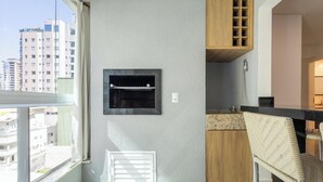 Una cocina moderna con horno empotrado, armarios de madera y vistas a la ciudad.