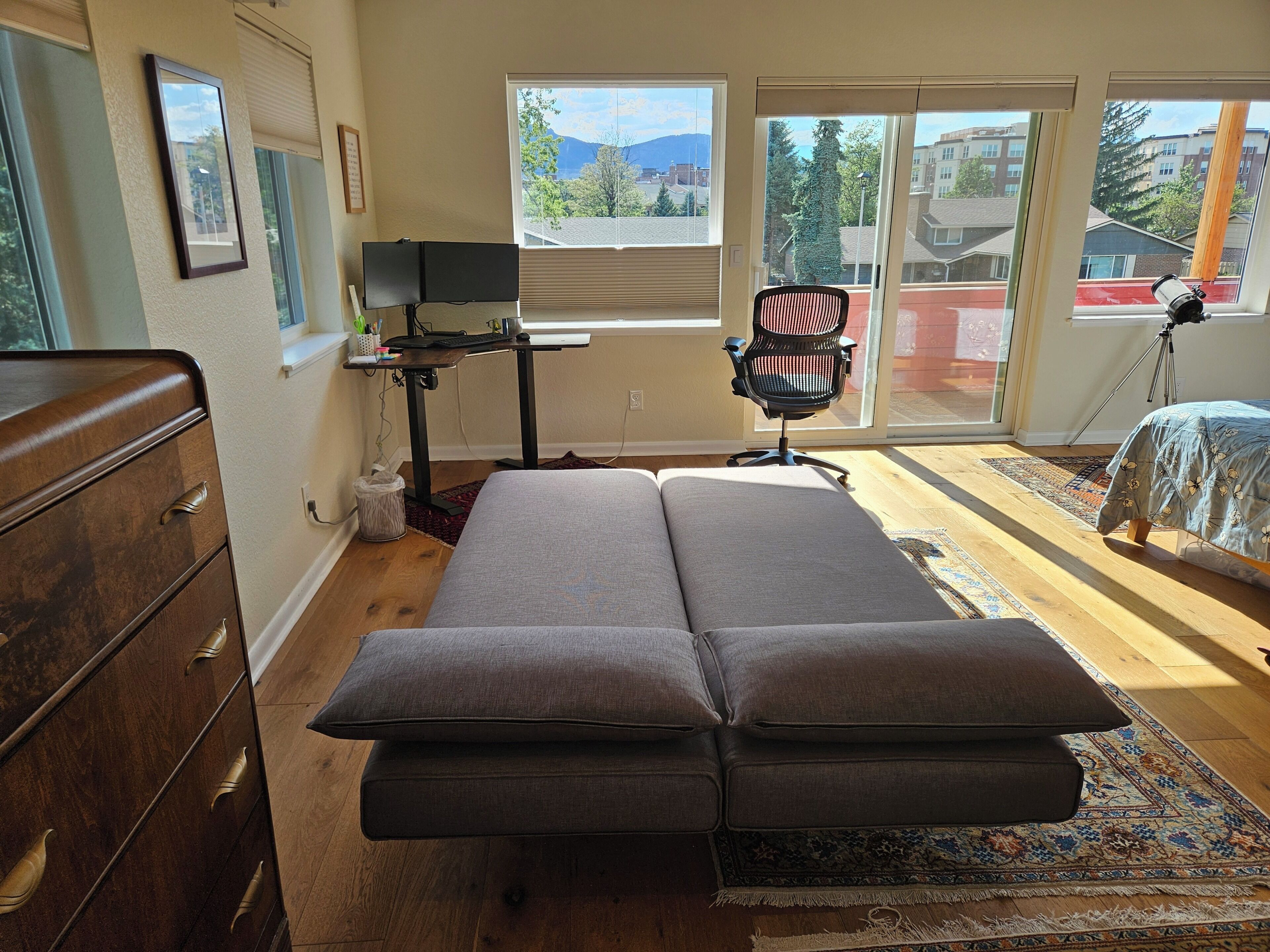 Une pièce comprenant un lit, un bureau, une chaise et une fenêtre donnant sur l’extérieur.
