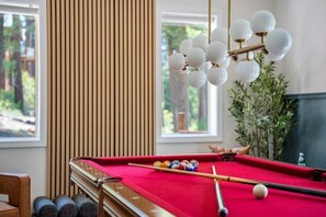 A pool table with balls, a cue stick, and a hanging lamp. - Karaoke, Pool Table, Arcade, Outdoor Games, Bubble Dome, Grill, Spa: Starfall Lodge (Tahoe Vista)