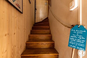 Eine Holztreppe mit einem Schild an der Wand.