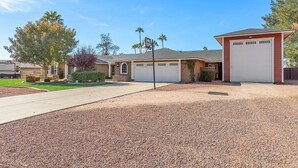A residential property with a driveway, garage, and landscaped yard. - Private Scottsdale Oasis - Pool, Spa & Casita (Scottsdale)