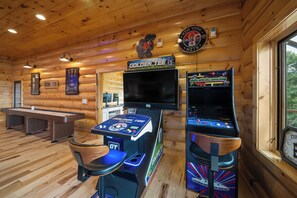 A wooden interior with a pool table, a bar area, and arcade machines. - Grandfather Mountain Views, Hot Tub, Game Room & Putting Green (Seven Devils)