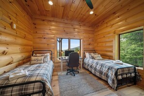 A cabin with two beds, a desk, and a computer. - Grandfather Mountain Views, Hot Tub, Game Room & Putting Green (Seven Devils)