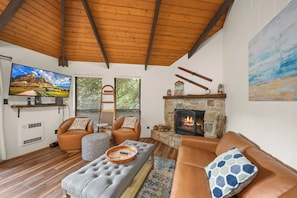 A cozy living room with a fireplace, comfortable seating, and a television. - Cozy 2BR retreat near Beech Mountain Resort. (Beech Mountain)