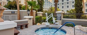 A hot tub area with a sign indicating a 6-person capacity.