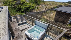 A hot tub on a wooden deck with a view of the surrounding landscape. - Miwok Escape, by Vinifera Homes (Bodega Bay)