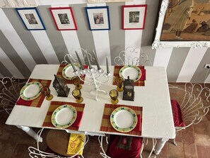A dining table set with plates, glasses, and a candelabra. - la torretta 23 (Marittima)