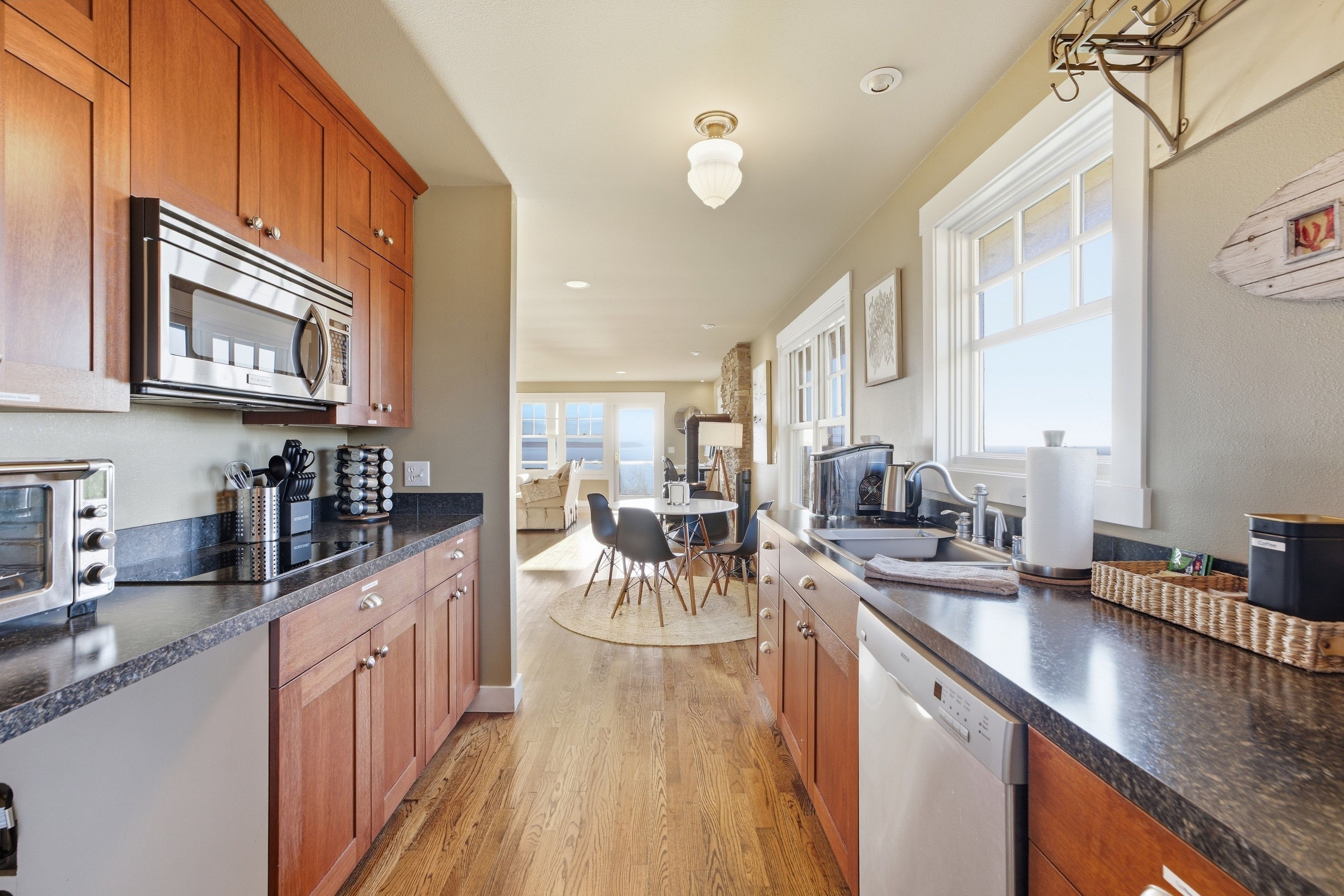 A modern kitchen with wooden cabinets, stainless steel appliances, and a central island.