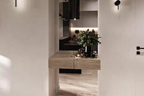 A modern interior with a wooden floor, a plant, and a minimalist design. - A Comfortable Apartment in the Center of Lodz (Łódź)