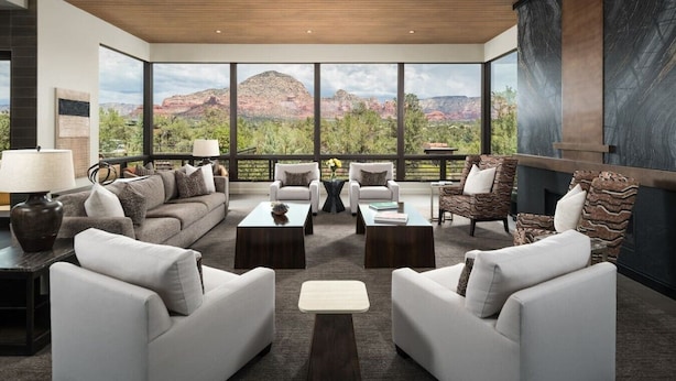 A modern living room with a large window overlooking a mountainous landscape. - Signature Designer Home | Views, Wellness, Games (Sedona)