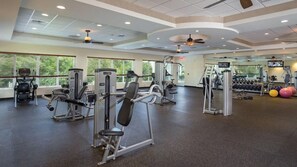 A gym with various exercise machines, a television, and a large window. - Wyndham Bali Hai Spacious 2-bedroom condo with AC in beautiful Princeville (Princeville)