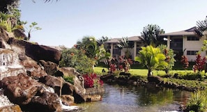 A hotel with a landscaped garden, a small waterfall, and a pool. - Wyndham Bali Hai Spacious 2-bedroom condo with AC in beautiful Princeville (Princeville)