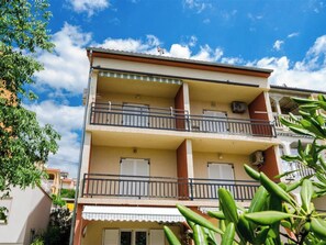 A multi-story residential building with balconies, windows with shutters, and an air conditioning unit. - TATALOVIC / HR-09816-01 by Interhome (Crikvenica)
