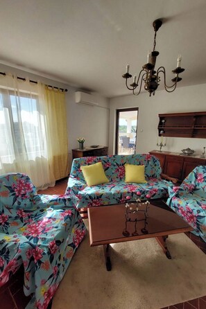 A living room with a sofa set, a coffee table, and a chandelier. - Apartment 945 by Interhome (Medulin)