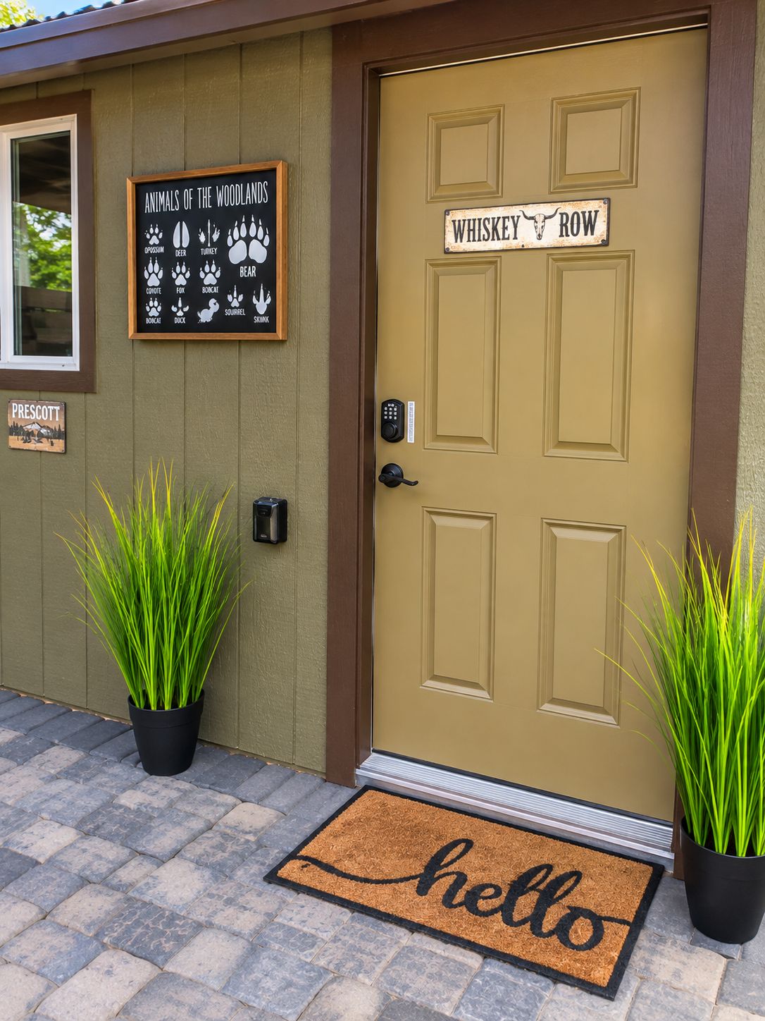 A door with a sign reading 'WHISKEY ROW' and a welcome mat with 'hello' on it.