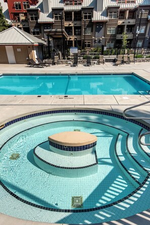 A swimming pool with a no diving sign, lounge chairs, and a sun deck. - Whistler Creekside Stay | Modern Kitchen & Scenic Views | Near Gondola (Whistler)