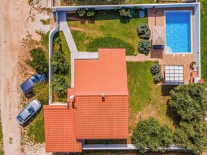 An aerial view of a house with a swimming pool, two cars, and a well-maintained lawn. - Villa Demian by Interhome (Pula/Banjole)