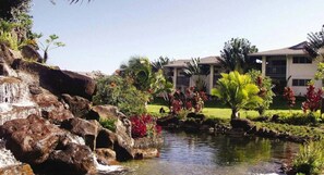 A hotel with a landscaped garden, a small waterfall, and a pool. - North Shore living 2-bedroom condo in delightful Princeville's Wyndham Bali Hai (Princeville)