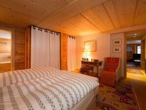 A cozy room with a bed, a desk, and a chair. - Chalet François, (Champery). by Interhome (Champery)