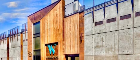 A modern building with a wooden facade and a large 'WORLD SPA' sign.