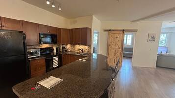 Coffee/tea maker, fridge, microwave, oven