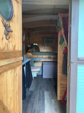 A compact RV interior with a bunk bed, a small kitchenette, and a storage area. -     Gypsy Mini Charming Tiny Cabin at Red Canoe Lodge with Resort Amenities (Clifton)