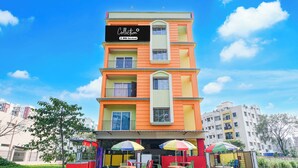 A multi-story building with balconies and a sign that reads 'Collection OYO-Serviced'. - Collection O Eco Park Kolkata (Barasat)