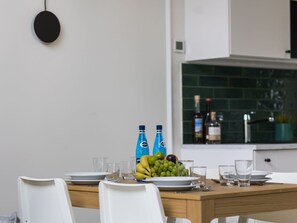A dining table set with plates, glasses, and a fruit bowl. - in Niechorze mit Großem Grill by Interhome (Niechorze)