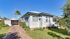 A single-story house with a front porch, a garage, and a well-maintained lawn. - Morpeth Cottage | In the hear of Morpeth (Morpeth)