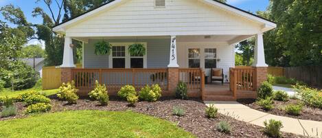 A single-story house with a front porch, a mailbox, and a well-maintained lawn.
