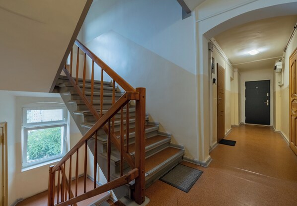 A staircase with wooden railings leading to a landing.