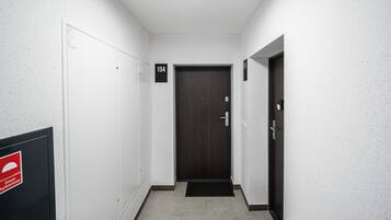 A hallway with a door marked '104' and a fire safety sign on the wall.
