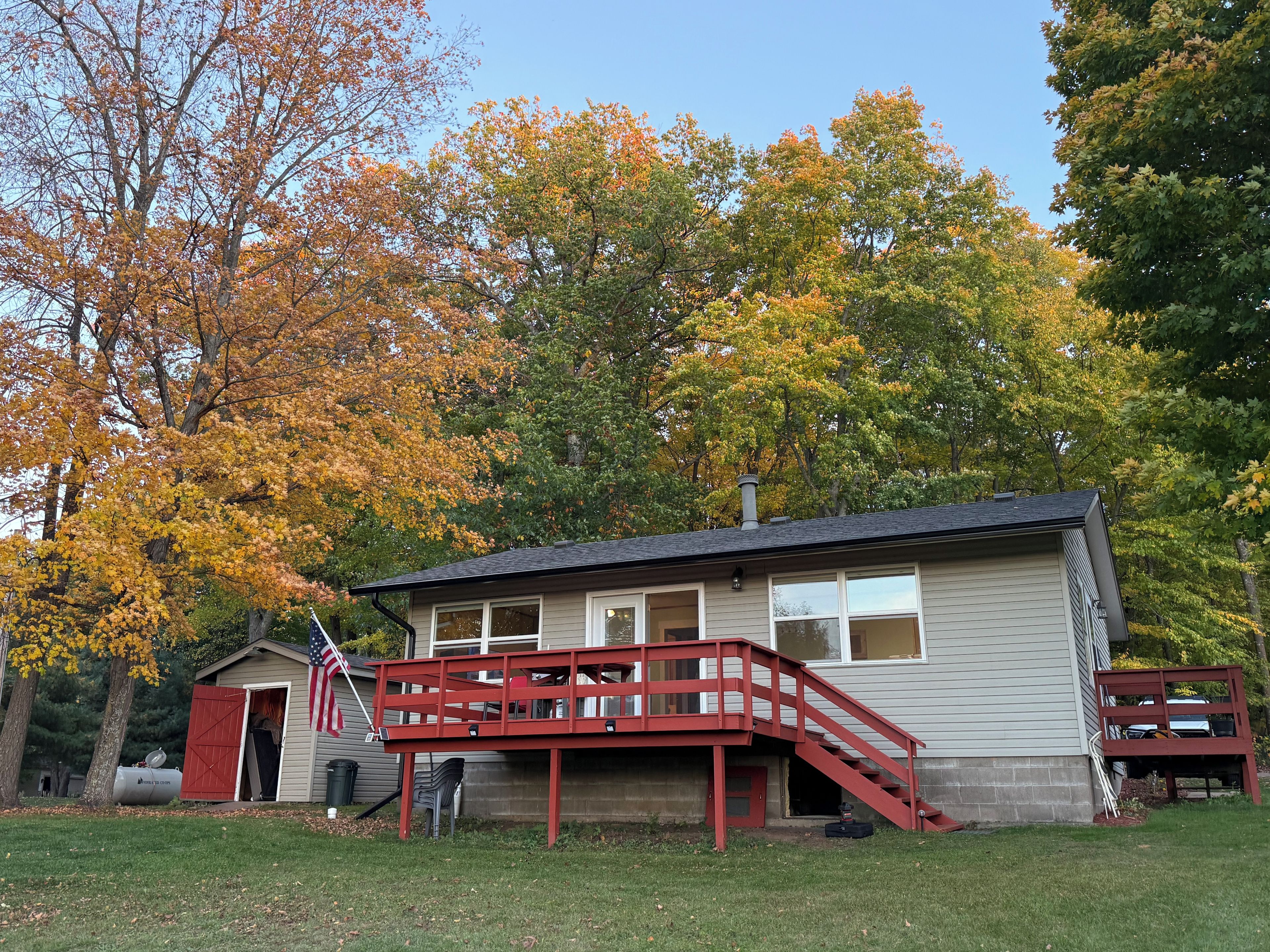 A two-story building with a red staircase and a small shed.