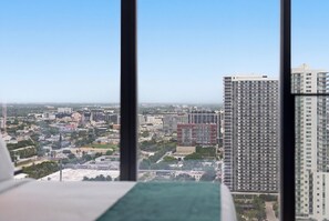 A high-rise building with multiple floors, a clear sky, and a distant view of a cityscape. - Deluxe E11EVEN Suite with Elite Amenities (Miami)