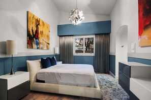 A modern hotel room with a bed, bedside tables, a large abstract painting, a window with curtains, and a chandelier. - $5Mil Luxury Estate - Pickleball Pool Hot Tub (Scottsdale)