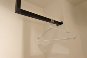 A wall-mounted hook with a clear plastic hanger. - Benten Yutaka (Minato Ward)