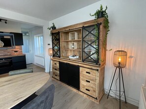 A modern kitchen with wooden cabinetry, a built-in bench, and a pendant light. - Nordseeblick by Interhome (Katwijk)