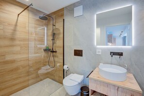 A modern bathroom with a glass-enclosed shower, a white sink, and a large mirror. - Residenza Castanea 202 San Bernardino Alpine Apartments, San Bernardino, Switzerland (San Bernardino)