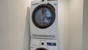 A stacked washer and dryer unit in a laundry room.