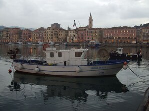 A boat named DANIELA IM 1023 docked at a harbor with buildings in the background. - Due Anime Felice by Interhome (Vasia)