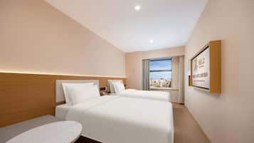 Habitación empresarial con 2 camas individuales, vista a la ciudad | Escritorio, espacio para trabajar con laptop y cortinas blackout